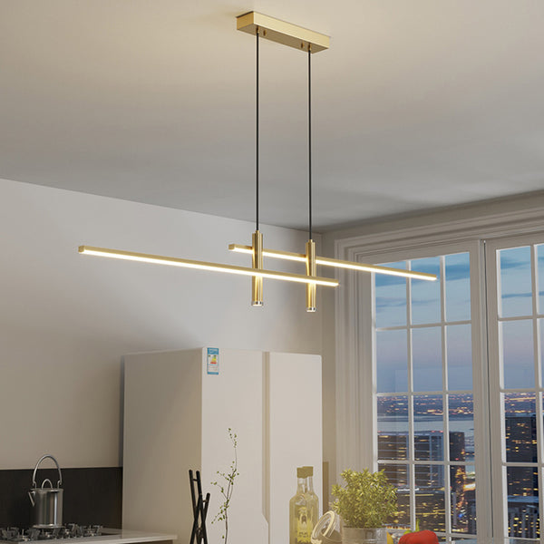 Gold modern linear pendant light hanging over a kitchen island