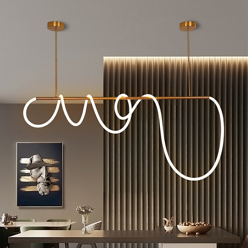 Brass color linear pendant light with silicon LED rope wrapped around it hanging over the table